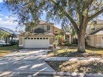 Charming two-story home featuring a two car garage, neutral color palette, and a well-manicured front yard at 380 Morning Glory Dr, Lake Mary, FL 32746