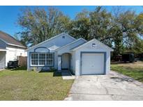 Charming one-story home featuring a well-maintained lawn, driveway, and attached one-car garage at 9329 Dearmont Ave, Orlando, FL 32825