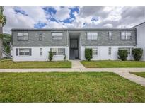 Low-rise apartment building featuring a well-kept lawn and a central staircase leading to the second floor units at 1000 S Semoran Blvd # 511, Winter Park, FL 32792