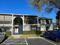 Condo exterior featuring a staircase to the second story with a blue car parked nearby at 1324 S Pine Ridge Cir # D2, Sanford, FL 32773