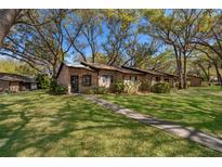 Charming brick townhouse with a well-maintained lawn and mature shade trees at 1735 Foxhall Cir # 1735, Kissimmee, FL 34741