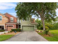 Charming two-story townhome featuring a well-manicured lawn and an attached two-car garage at 2015 Shalimar Loop, Sanford, FL 32773