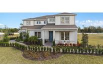 Beautiful two-story home featuring a manicured lawn, lush landscaping, and charming front porch seating at 2141 Weatherly Way, Orlando, FL 32820