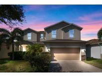 Charming two-story home with well-maintained landscaping and a brick driveway at 3213 Bayou Ln, Tavares, FL 32778