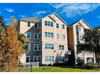 Charming condo building showcasing architectural details, lush landscaping and inviting curb appeal at 3428 Soho St # 308, Orlando, FL 32835