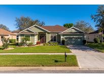 Charming single-story home with well-manicured lawn, mature landscaping, and inviting curb appeal at 3696 Peacepipe Ct, Clermont, FL 34711