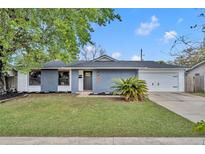 Charming single-story home with a well-manicured lawn, painted brick, and attached two-car garage at 6373 Forecastle Ct, Orlando, FL 32807