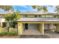 Charming home featuring a covered parking space and a cozy front entrance at 7466 Canford Ct # 25, Winter Park, FL 32792