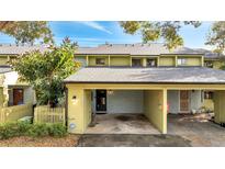 Charming townhome featuring a covered parking area and well-maintained front yard at 7466 Canford Ct # 25, Winter Park, FL 32792