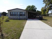 Charming single-story home with a long driveway and lush green lawn at 361 Wade Park Ct, Davenport, FL 33897