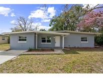 Charming single-story home with a gray brick facade, white trim, and a well-maintained front lawn at 1205 Flewelling Ave, Ocoee, FL 34761