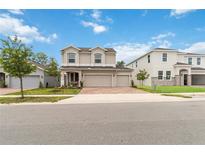 Inviting two-story home featuring a three-car garage and well-manicured lawn in a desirable neighborhood at 1212 Bear Oak Ln, Deland, FL 32720