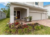 Charming front porch with comfortable seating and colorful flower garden at 1212 Bear Oak Ln, Deland, FL 32720