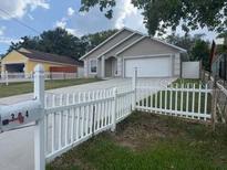 Charming home with a well-maintained front yard and a white picket fence at 304 N Hastings St, Orlando, FL 32835