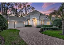 Stunning home with a circular driveway, manicured landscaping, and a two-car garage at 3334 Park Grove Ct, Longwood, FL 32779