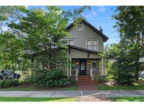 Charming two-story home with inviting front porch and manicured landscaping at 421 Broadway Ave, Orlando, FL 32803