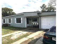 Modest single-story home with a light gray paint scheme and attached garage at 7018 Stockholm Way, Orlando, FL 32822