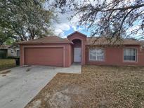 Charming single-story home with a well-maintained yard and attached two-car garage at 721 Waxwing Ct, Kissimmee, FL 34759