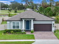 Charming single-story home with a well-maintained lawn, beautiful landscaping, and a two-car garage at 1740 Standing Rock Cir, Oakland, FL 34787