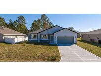 Charming single-story home with a well-manicured lawn and attached two-car garage at 1857 Manitoba Ct, Poinciana, FL 34759