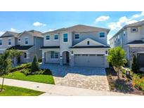 Beautifully landscaped two-story home features a paved driveway and welcoming entrance at 288 Auburn Ave, Kissimmee, FL 34747