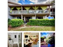 Attractive condo exterior with manicured shrubs and balcony featuring privacy curtains at 402 Cypress Dr # 402, Haines City, FL 33844