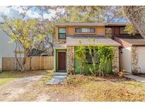 Charming townhome exterior features unique rock accents and lush landscaping at 12240 Huntsman Ln, Orlando, FL 32826