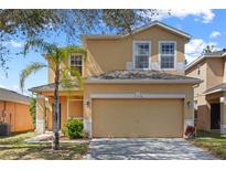 Two-story home featuring an attached two-car garage, well-maintained lawn and simple landscaping at 176 Blue Jay Way, Davenport, FL 33896