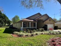 Charming single-Gathering home with well-manicured lawn and inviting front porch at 2801 Hardenbergh Ln, Eustis, FL 32726