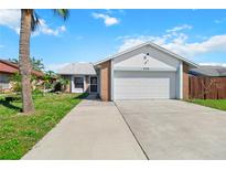 Charming single-Gathering home boasting a two-car garage and beautiful lawn at 3175 Arrowhead Ln, Kissimmee, FL 34746