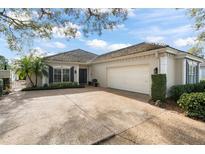 Charming single-story home featuring a large driveway and well-maintained landscaping at 5940 Chesapeake Park, Unit # 47, Orlando, FL 32819