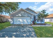 Charming single-story home with well-maintained lawn and two-car garage at 8630 Fort Jefferson Blvd, Orlando, FL 32822