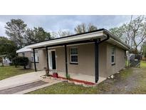 Charming single-story home with a covered porch and landscaped flowerbeds at 11618 Churchill St, Orlando, FL 32817
