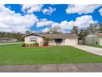 Charming single-story home features a manicured lawn, driveway, and inviting front entry at 147 13Th Ave, Longwood, FL 32750