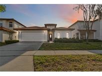 Charming single-story home with a well-maintained lawn and a red tile roof at 16613 Caribbean Breeze Way # 34714, Clermont, FL 34714