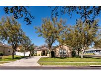 Charming single-story home with solar panels and a well-manicured lawn surrounded by mature trees at 2005 Blackbird Dr, Apopka, FL 32703