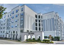 Modern condo building exterior with manicured landscaping and a welcoming arched entrance at 206 E South St # 1018, Orlando, FL 32801