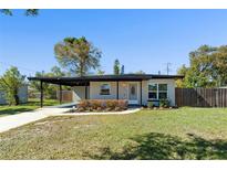 Charming single-story home featuring a well-maintained front yard and a covered carport at 212 Oakland Ave, Sanford, FL 32773