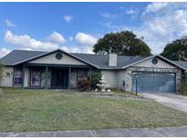 Charming one-story home featuring a spacious front yard with a decorative fountain at 2831 S M U Blvd, Orlando, FL 32817