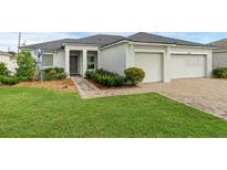 Beautiful single-story home with a well-manicured lawn and a two-car garage at 359 Quarry Rock Cir, Kissimmee, FL 34758