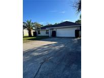 Charming single-story home with a well-maintained lawn and a spacious two-car garage at 813 Sylvia Dr, Deltona, FL 32725