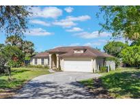 Charming single-story home with a well-manicured lawn, inviting curb appeal, and an attached two-car garage at 1306 Pleasantridge Pl, Orlando, FL 32835