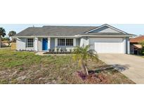 Charming single-story home with gray exterior, well-maintained lawn, and attached garage, offers curb appeal at 2169 Webster Ct, Deltona, FL 32738