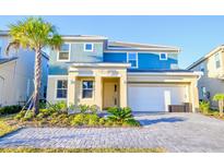 Beautiful two-story home featuring a modern design, well-maintained landscaping, and an attached two-car garage at 2555 Shanti Dr, Kissimmee, FL 34746