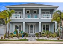 Charming two-story home featuring double balconies, lush landscaping, and a welcoming front entrance at 3114 Meleto Blvd, New Smyrna Beach, FL 32168