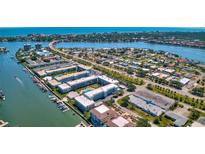 Enjoy this stunning aerial view of the coastal community with boat docks and serene waterfront views at 315 N Causeway # B302, New Smyrna Beach, FL 32169