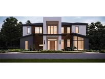 Striking modern two-story home with a dark-wood facade and minimalist landscaping at 7807 Loxahatchee Ct, Reunion, FL 34747