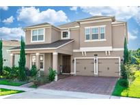 Stunning two-story home boasts a charming facade with a two-car garage and manicured landscaping at 889 Terrapin Dr, Debary, FL 32713