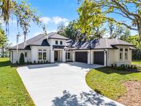 Beautiful new construction featuring a spacious three-car garage and modern architectural design at 1475 Warrior Trl, Enterprise, FL 32725