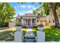 Charming home with inviting front porch, manicured lawn, and walkway leading to the entrance at 1900 Garvin St, Orlando, FL 32803